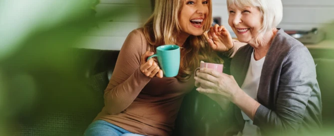 A family caregiver feeling the symptoms of caregiver burnout and seek help to Arbors memory care at Sparks, NV and the parent share a warm smile during a visit at Arbors Memory Care, Sparks, NV.