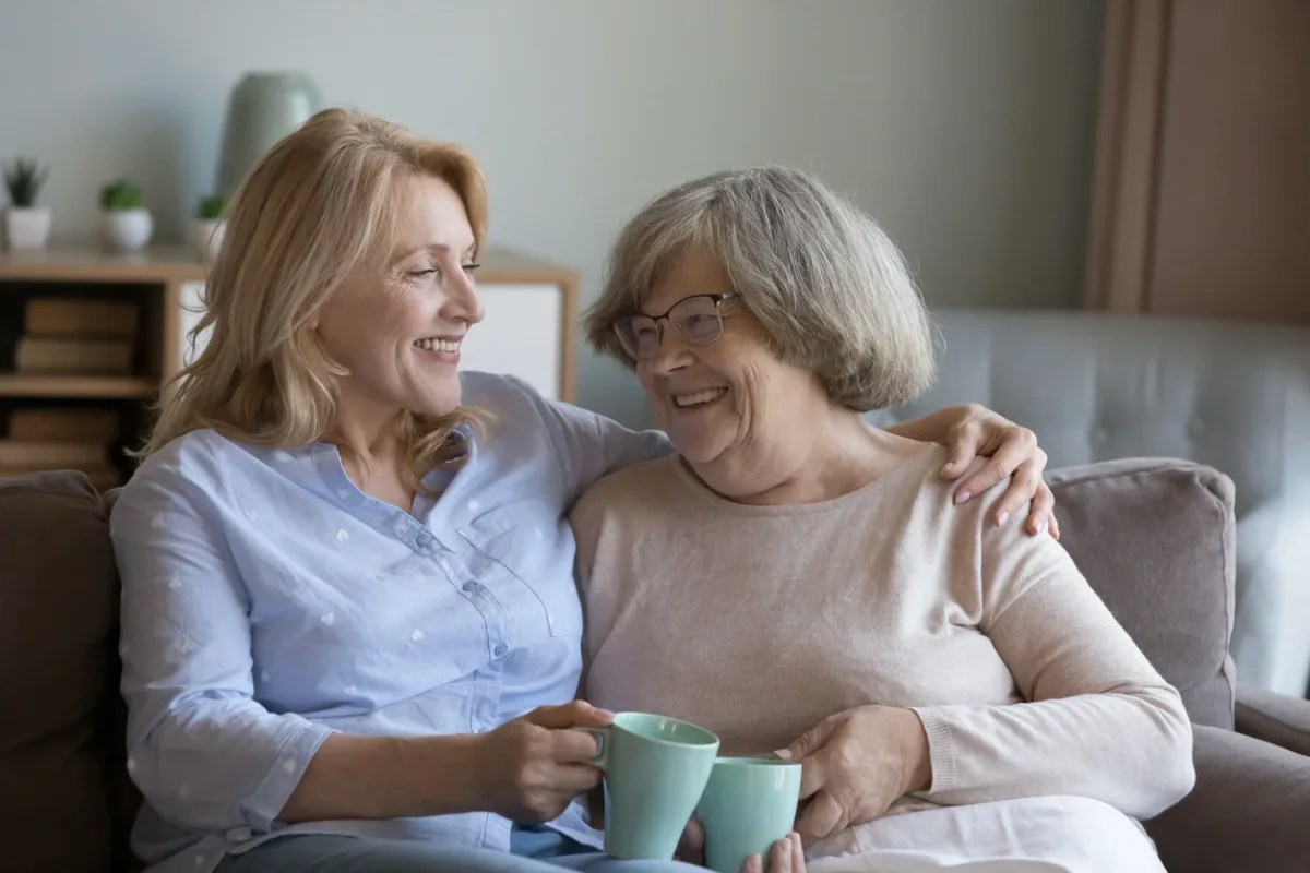 Signs It’s Time for Memory Care Adult woman hugging an older woman while discussing signs it's time for memory care